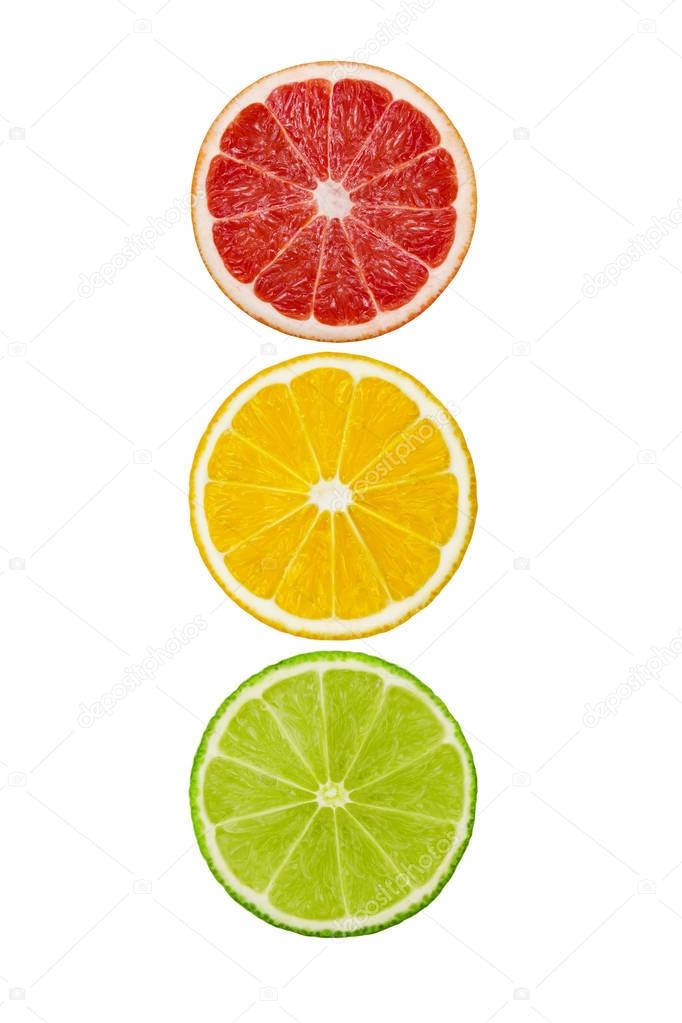 Slices of pink grapefruit, lemon and lime fruits isolated on white background