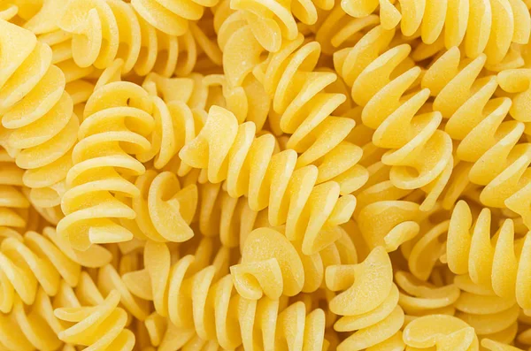 Pasta spiral. Closeup of uncooked Italian. Background of pasta — Stock Photo, Image