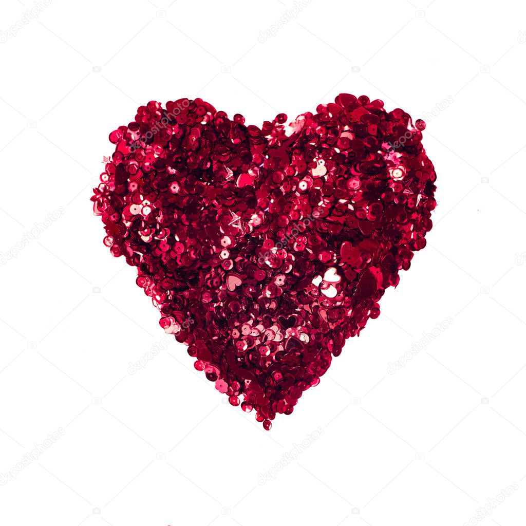 Decorative heart shaped made with red sparkles on white background