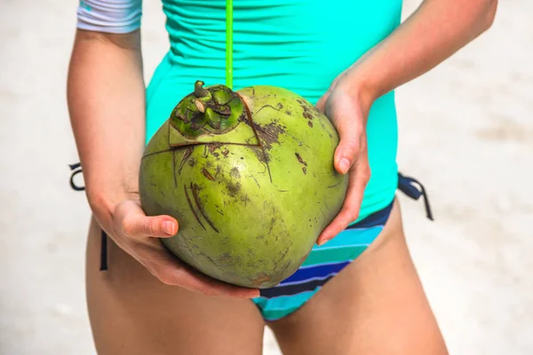 Green fresh coconut on woman hands — Stock Photo, Image