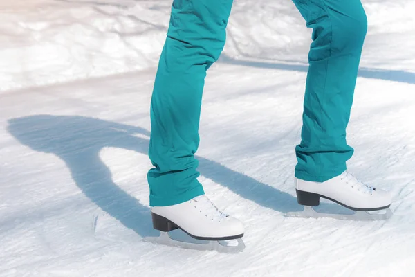 Female figure skates on the ice