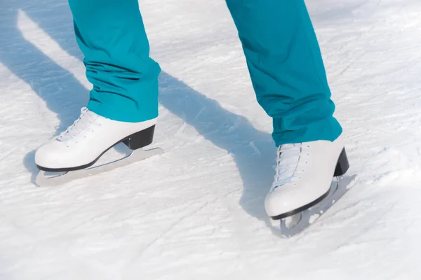 Female figure skates on the ice