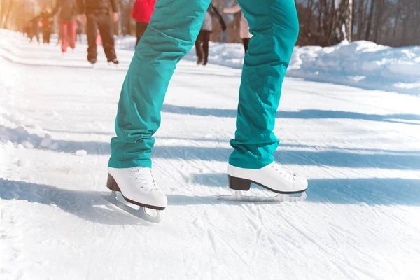 Female figure skates on the ice