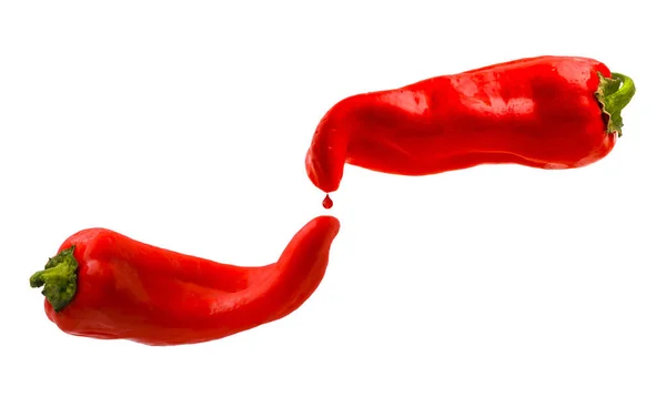 Pimentos vermelhos com gota vermelha isolada em um fundo branco — Fotografia de Stock