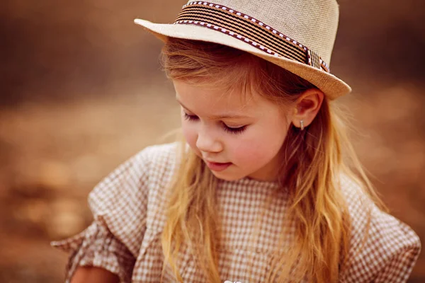 Sweet little girl outdoors with curly hair in the wind — Stock Photo, Image