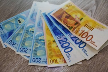 İsrail para - İsrail para yığınını arka plan üzerinde beyaz izole 100 ve 200 şekel banknotlar faturaları. Yeni İsrail Şekeli serisi C. seçici odak