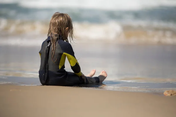Surfer girl relaxing near the ocean