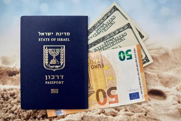 international passport of Israel with 50 euro and 100 dollars banknotes.