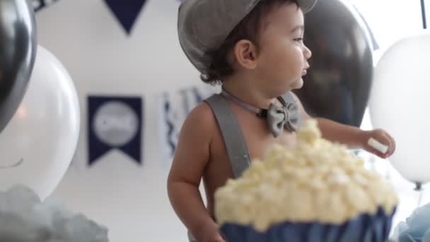 Boy Birthday Cake Smash. Adorable happy baby boy in a bright room. The baby smiling looking at camera. Retro style — Stock Video