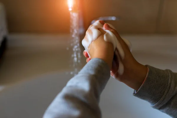 手を洗え。バスルームに流れる水を背景に、適切な技術と抗菌石鹸で手を洗う — ストック写真