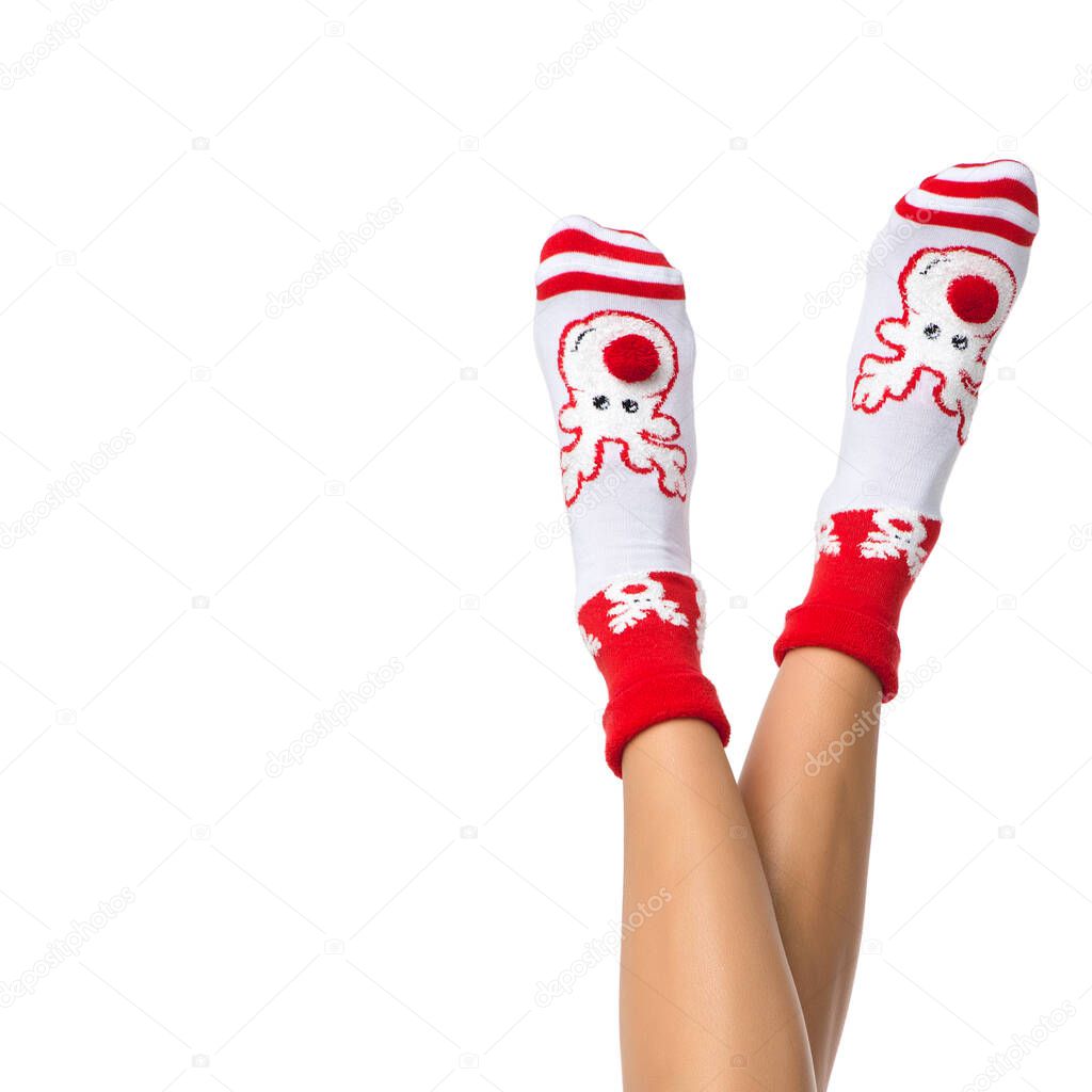 woman legs in color red socks isolated on white, legs in Christmas socks