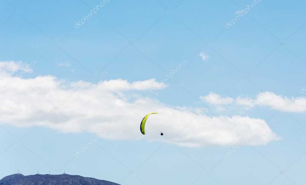 Flight to paraplene on the background of mountains and blue sky 