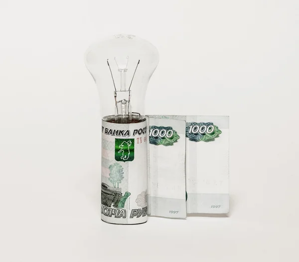 Elektrisk lampa lampor och sedlar står upprätt på en grå bakgrund — Stockfoto