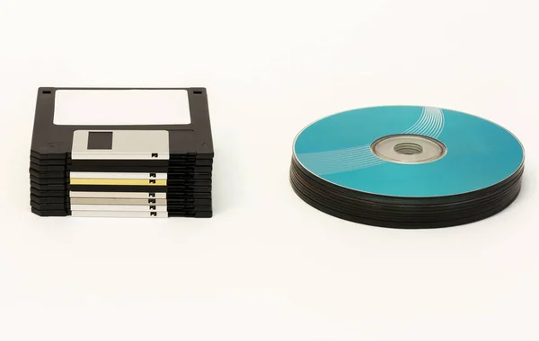 Floppy disks and CD / DVD - disk wheels on a white background — Stock Photo, Image