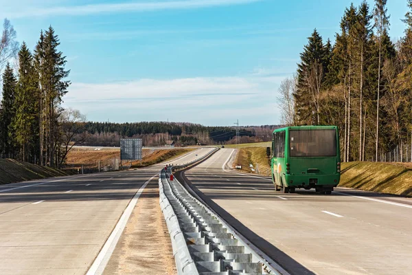 Passenger bus of green color goes by road — Stock Photo, Image