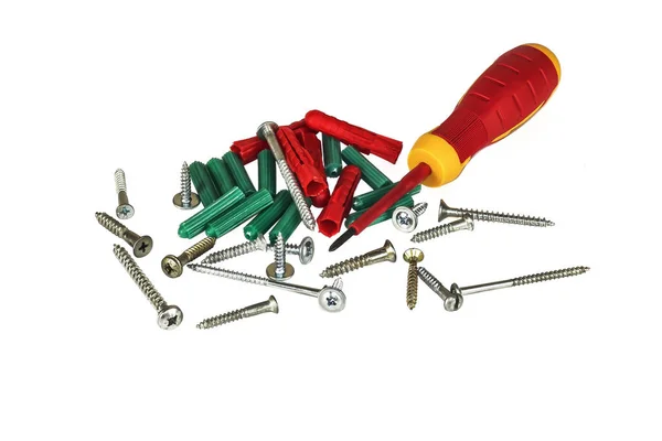 Screwdriver, screws and plastic dowels — Stock Image Screwdriver, screws and plastic dowels Stock Photo