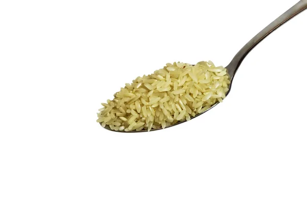 A metal spoon with rice cereal on a white background — Stock Photo, Image