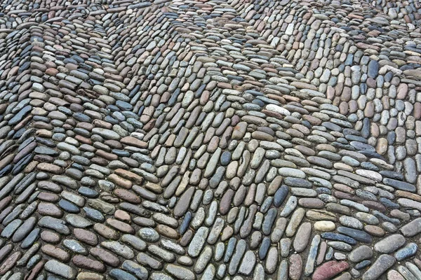 A estrada é feita de pedra natural, calçada de paralelepípedos. Backgro. — Fotografia de Stock