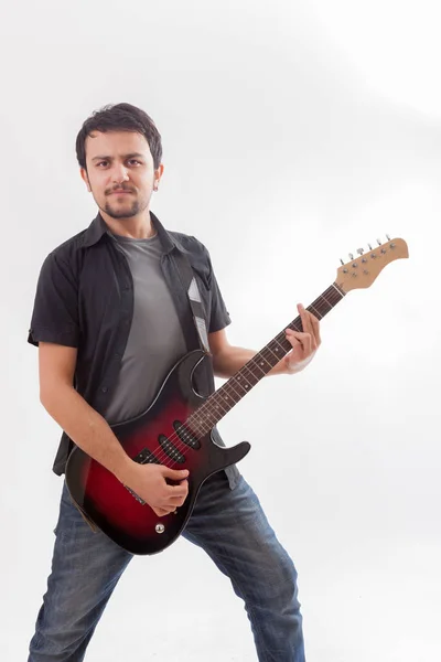 Young man jumping with electric guitar — Stock Photo, Image