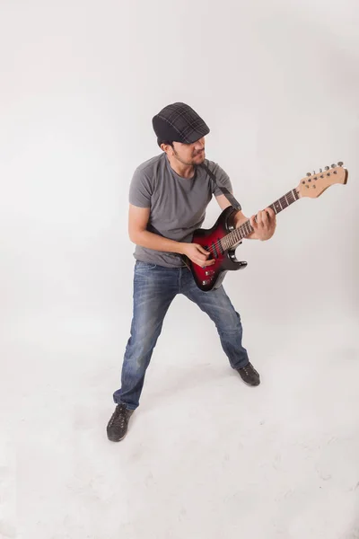 Young man jumping with electric guitar Stock Photo