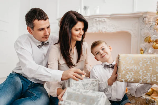 Familia cerca de la chimenea con regalos de Navidad —  Fotos de Stock