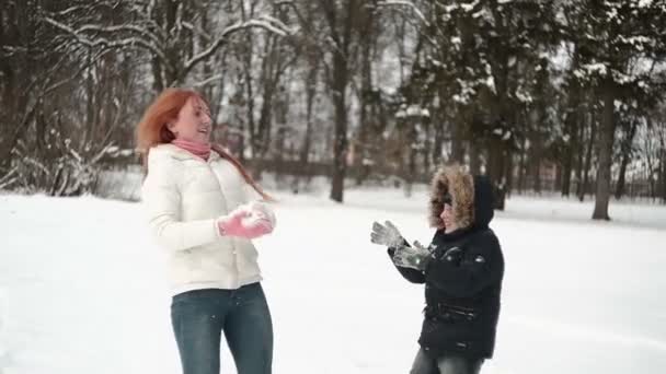 Мать и сын веселятся в снегу прекрасный зимний день — стоковое видео