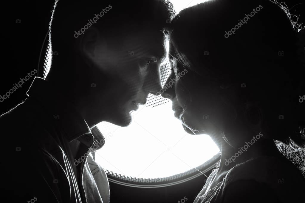 silhouette of a loving couple in the rays of light