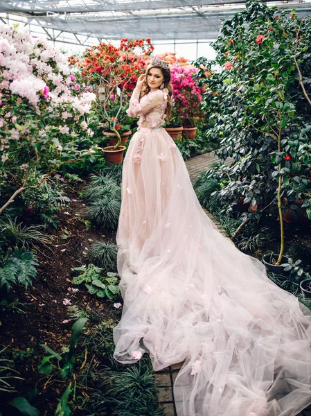 Belle femme dans une robe couleur pêche avec un long train — Photo