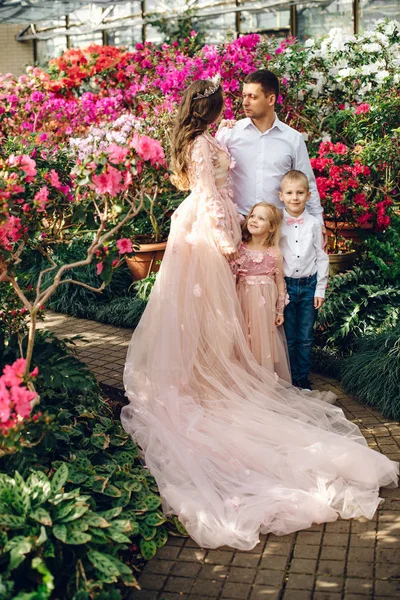 Young happy family in a blooming spring garden