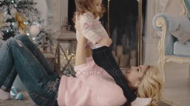 genç anne ile kızı Noel ağacı yakınındaki çalış