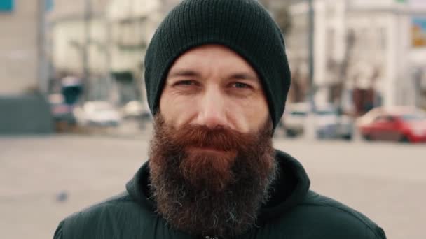 Portrait of a young bearded smiling man on the street — Stock Video