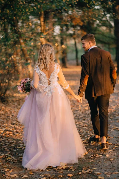 Portrait of happy newlyweds during a walk in the forest — Stock Photo, Image