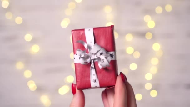 Close-up of a womans fingers holding a small box of gift. — Stock Video