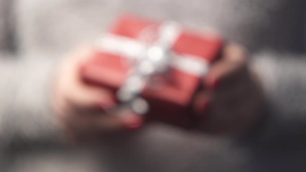 Close-up of the hands of a woman holding a box with a gift. — 비디오