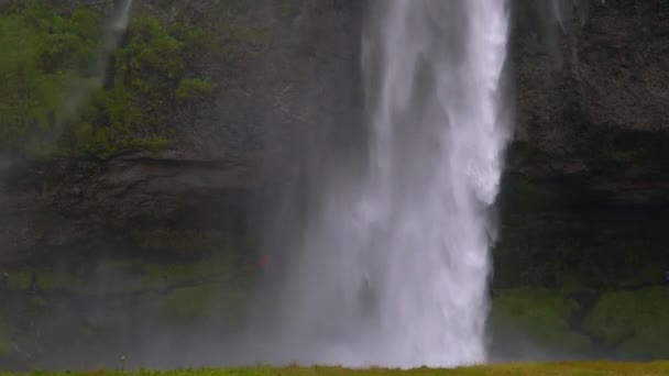 Water flows down a powerful stream at a waterfall. — Stock Video