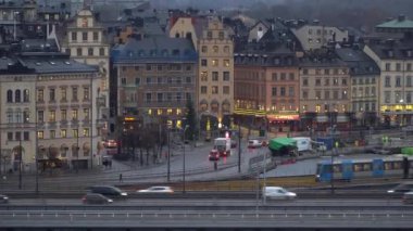 Stockholm, İsveç - 4 Aralık 2019: Gamla Stan şehrinin tarihi kısmının arka planından bir metro treni geçiyor.