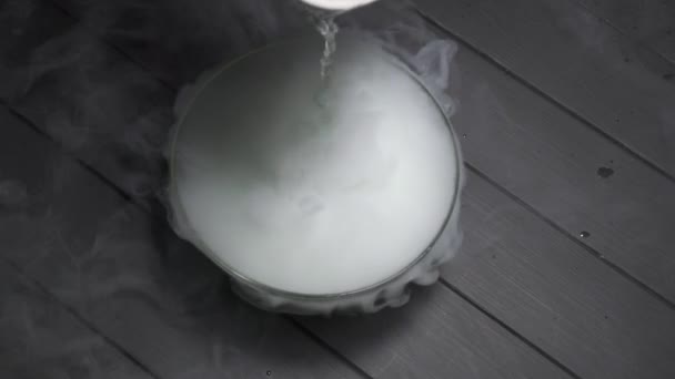 The chemical reaction of dry ice to the addition of water. — Stock Video