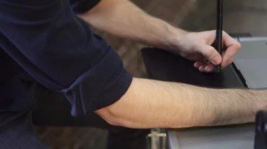 Bir erkek fotoğrafçının elleri, tasarımcı grafik tableti kullanır.