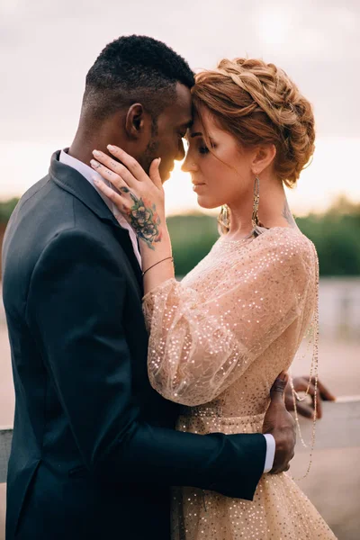 İki aşık gün batımında sarılır.