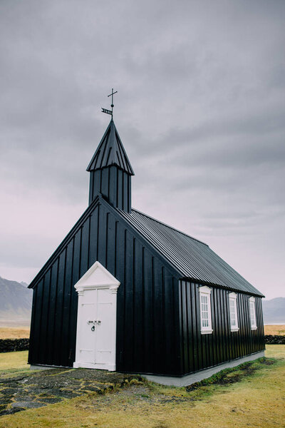 Icelandic landscape with a black church.