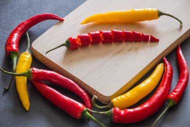 Taş karanlık bir tablo üzerinde renkli sıcak kırmızı biber