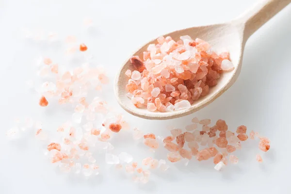 Himalayan salt on the spoon and white table — Stock Photo, Image