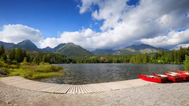 Panorama mountain lake Strbske Pleso Tatra Dağları'nda. Summers'ın renkleri ve yüzme için tekne