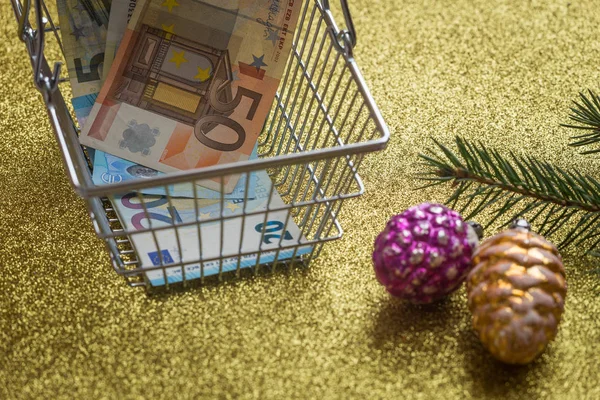 Christmas expenses / concept / Euro money in the shopping cart
