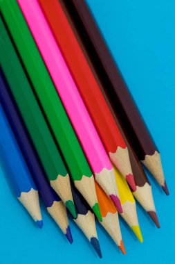 Mavi arka planda çok renkli kalemler. Okul kavramı