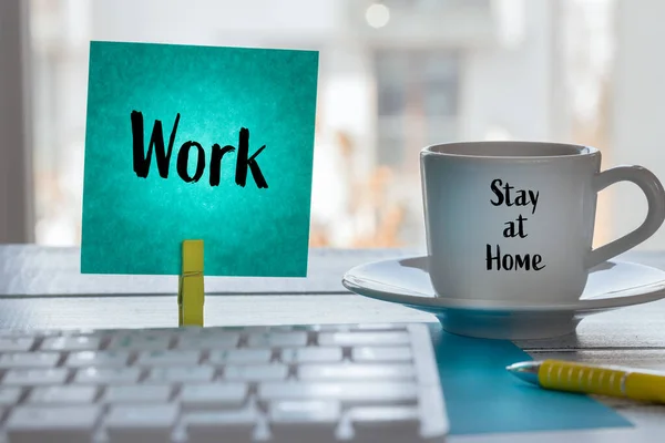 Work at home during the Coronavirus epidemic. A card with the words Work and a cup of coffee with the slogan \
