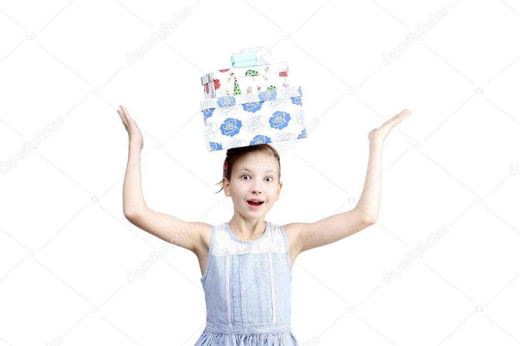 the portrait of young little girl with present boxes on head holding hands-up over white background