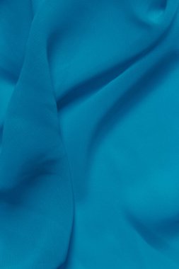 Mavi tekstil dokusunun bulanık görüntüsü, mavi renk, dikey görüntü. Soyut doku arkaplanı, metin için boşluk.