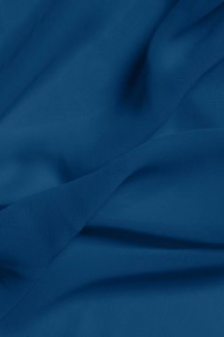 Mavi tekstil dokusunun bulanık görüntüsü, mavi renk, dikey görüntü. Soyut doku arkaplanı, metin için boşluk.