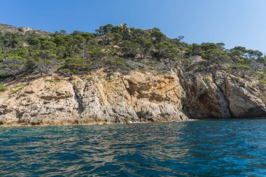 Güneşli bir günde güzel bir kayalık manzara üzerinde denizden görüntülemek